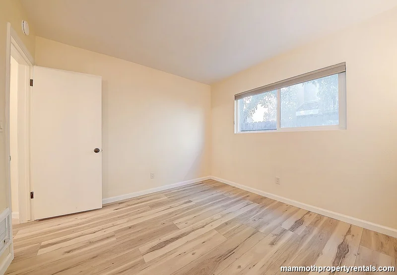 Second bedroom with natural light and practical layout.