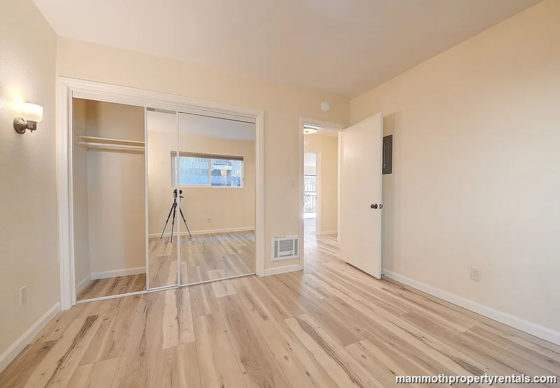 Second bedroom - showing closet access, window placement, and open floor space.