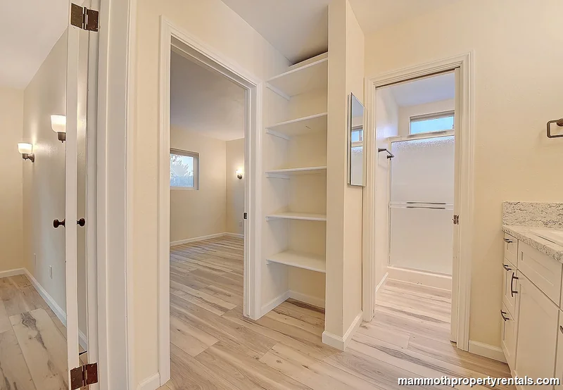 Central hallway connecting bedrooms, bathrooms, and living areas.